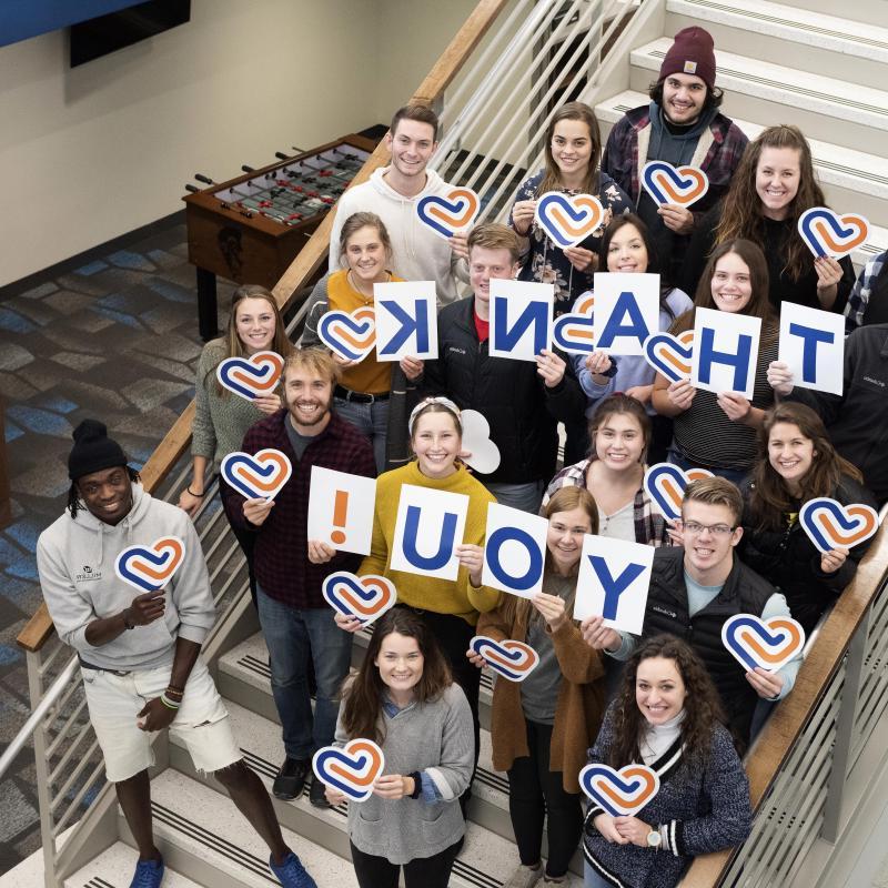 Group of students holding thank you signs for the University of Mary’s giving day.